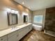 Main bathroom featuring double vanities, modern fixtures, a soaking tub, and a walk in shower at 563 Pleasant Grove Dr, Winter Springs, FL 32708