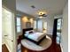 Comfortable main bedroom featuring stylish furnishings, wooden floors, and a ceiling fan at 563 Pleasant Grove Dr, Winter Springs, FL 32708