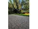 Brick-paved patio perfect for outdoor seating and relaxation amid the well-manicured backyard at 563 Pleasant Grove Dr, Winter Springs, FL 32708