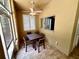 Outdoor patio with tile flooring, ceiling fan, windows, and furniture seating for four at 563 Pleasant Grove Dr, Winter Springs, FL 32708