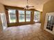 Enclosed sun room with tiled floor and multiple windows leading to the backyard at 563 Pleasant Grove Dr, Winter Springs, FL 32708