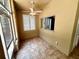 Sun room with tiled floor and multiple windows and view into kitchen and back yard at 563 Pleasant Grove Dr, Winter Springs, FL 32708