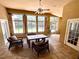 Bright sun room with large windows, wicker furniture, tile flooring, and a ceiling fan at 563 Pleasant Grove Dr, Winter Springs, FL 32708