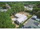 Aerial view showcases a home with mature trees surrounding the property and nearby homes with solar panels at 6327 Ridgeberry Dr, Orlando, FL 32819