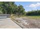 Large backyard with a grill area, concrete patio, and garden area at 6327 Ridgeberry Dr, Orlando, FL 32819