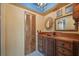 Bathroom with ornate wooden vanity, intricate mirror, and unique ceiling design at 6327 Ridgeberry Dr, Orlando, FL 32819
