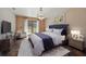 Beautifully furnished bedroom with a luxury bed, chandelier lighting, and a walk-out to the yard at 6327 Ridgeberry Dr, Orlando, FL 32819