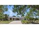 Charming single-story home features a stone accent wall, a wide driveway, and lush, mature landscaping at 6327 Ridgeberry Dr, Orlando, FL 32819