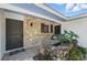 Inviting stone front entrance with rock fountain and mature foliage at 6327 Ridgeberry Dr, Orlando, FL 32819