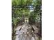Stone benches line a garden path framed by an iron trellis covered in greenery at 6327 Ridgeberry Dr, Orlando, FL 32819