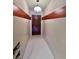 Entry hallway features textured walls, tiled floor, a modern pendant light, and a solid wood door at 6327 Ridgeberry Dr, Orlando, FL 32819