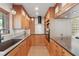 Bright kitchen with wood cabinets, updated appliances, stylish lighting, and granite countertops at 6327 Ridgeberry Dr, Orlando, FL 32819