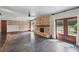 Spacious living room featuring a stone fireplace, stained concrete floors, and access to the exterior patio at 6327 Ridgeberry Dr, Orlando, FL 32819