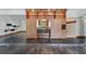 Open-concept living area showcases a wood built-in bar with seating and access to the kitchen at 6327 Ridgeberry Dr, Orlando, FL 32819