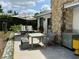 Outdoor dining area with umbrella, stone chimney, and well-maintained yard at 6327 Ridgeberry Dr, Orlando, FL 32819