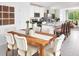 Open concept dining area with wood table with seating flowing into kitchen with island and living space at 658 Pennywort St, Lake Alfred, FL 33850