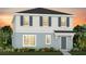 Charming two-story home with a modern design, blue accents, and lush landscaping at 6931 Copperwood Ave, Orlando, FL 32829