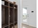 Organized entryway featuring built-in shelving and storage, leading to a bright doorway with outdoor views at 7420 Ivy Tendril Ave, Orlando, FL 32829