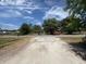 Street view showing the home's access point on a sunny day with mature trees at 749 Saddlewood Blvd, Lakeland, FL 33809