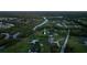 Beautiful waterfront property with lush landscaping and neighborhood in the distance at 775 Bay Dr, New Smyrna Beach, FL 32168