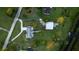 Aerial view of property showcasing driveway, landscaping and proximity to water at 775 Bay Dr, New Smyrna Beach, FL 32168