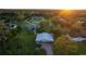 Expansive property with a home, workshop, mature trees, and lush green lawn at 775 Bay Dr, New Smyrna Beach, FL 32168
