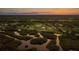 Scenic waterfront property with lush greenery, mature trees, and a beautiful sunset backdrop at 775 Bay Dr, New Smyrna Beach, FL 32168