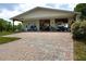 Exterior of barn featuring a brick paver driveway and covered workspace at 775 Bay Dr, New Smyrna Beach, FL 32168