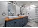 Modern bathroom with dual vanities, wood countertops, and a tiled shower at 775 Bay Dr, New Smyrna Beach, FL 32168