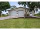 Large detached garage with two doors, a well-manicured lawn, and brick driveway at 775 Bay Dr, New Smyrna Beach, FL 32168