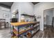 Functional kitchenette with wooden countertop, open shelving, and a sink at 775 Bay Dr, New Smyrna Beach, FL 32168