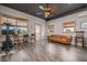 Modern living room with wood flooring, exposed ceiling, and comfortable seating area at 775 Bay Dr, New Smyrna Beach, FL 32168