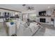 Cozy living space with a brick fireplace, neutral furniture, and a view of the kitchen at 775 Bay Dr, New Smyrna Beach, FL 32168
