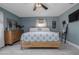 Bright main bedroom featuring light wood floors, ceiling fan, and a comfortable bed at 775 Bay Dr, New Smyrna Beach, FL 32168