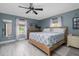 Spacious main bedroom with a ceiling fan, natural light and light wood floors at 775 Bay Dr, New Smyrna Beach, FL 32168