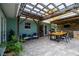 This patio showcases a built-in outdoor bar and grill, with ample seating and lush greenery at 775 Bay Dr, New Smyrna Beach, FL 32168