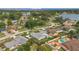 An aerial view of a quiet, residential neighborhood with homes and backyard pools near a large lake at 8134 Hook Cir, Orlando, FL 32836