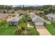 Expansive aerial view of a grey home with a large front yard, mature landscaping, and a two-car garage at 8134 Hook Cir, Orlando, FL 32836