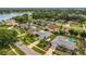 Aerial shot of a lakeside community with mature trees and well-maintained homes, some with swimming pools at 8134 Hook Cir, Orlando, FL 32836