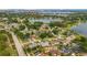 Wide aerial shot showcases a residential community surrounding a scenic lake, dotted with trees and homes at 8134 Hook Cir, Orlando, FL 32836