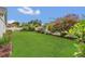 Spacious backyard features vibrant flowers and a well manicured lawn at 8134 Hook Cir, Orlando, FL 32836