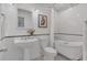 Bathroom featuring vintage tile, pedestal sink, and a claw foot tub at 8134 Hook Cir, Orlando, FL 32836