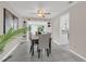 Bright dining room featuring contemporary furnishings and views into the sun room at 8134 Hook Cir, Orlando, FL 32836