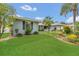 Landscaped front yard with lush green lawn and tidy shrubbery leading up to a well maintained home at 8134 Hook Cir, Orlando, FL 32836