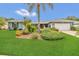 Charming home featuring a lush lawn, mature landscaping and a symmetrical exterior at 8134 Hook Cir, Orlando, FL 32836