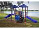Community playground with slides and play equipment near the water at 8134 Hook Cir, Orlando, FL 32836