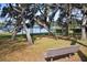 Community playground with swings near the water and mature trees at 8134 Hook Cir, Orlando, FL 32836