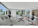 Bright sunroom with large windows offering views of the landscaped backyard at 8134 Hook Cir, Orlando, FL 32836