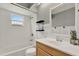 Bright bathroom features a white tile shower, wood vanity, and stylish decor at 840 Baybreeze Ln, Altamonte Springs, FL 32714