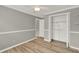 Bedroom showcasing wood floors, closet, neutral gray paint, and white trim at 840 Baybreeze Ln, Altamonte Springs, FL 32714